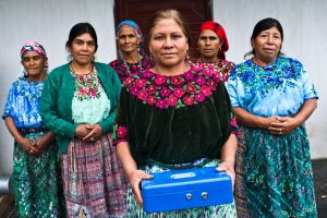 A group of female VSLA members standing with their lock box