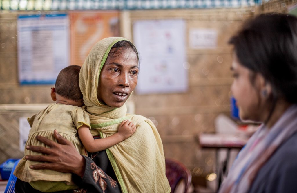 Woman with baby visiting health centre in Bangladesh